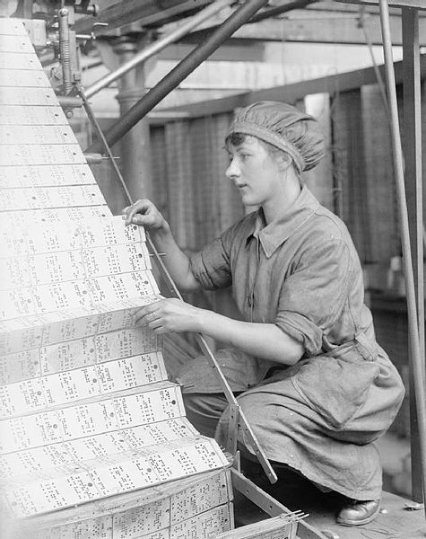 A female worker changing jacquard cards in a lace machine in a Nottingham factory during the First World War.